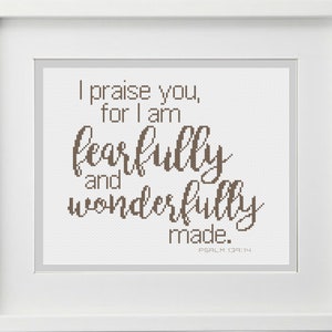 May include: A white framed cross-stitch with brown thread. The text reads "I praise you, for I am fearfully and wonderfully made. Psalm 139:14"
