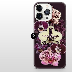 May include: A smartphone case with a floral design of orchids in shades of purple, white, and pink. The case has a dark purple background and a clear border. The orchids are arranged vertically.