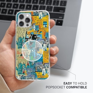 May include: Clear phone case with a colorful abstract art design in yellow, blue, and green. The case is shown with a PopSocket and the text "EASY TO HOLD POPSOCKET COMPATIBLE".