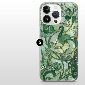 May include: A phone case with a green peacock and floral design. The case features a stained glass effect with shades of green, white, and a pearlescent finish. The design includes roses and leaves.