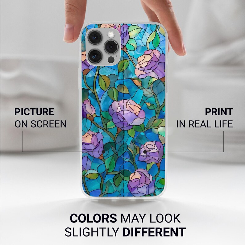May include: A clear phone case featuring a stained-glass design of purple roses and green leaves against a blue background. The text on the case reads "PICTURE ON SCREEN" and "PRINT IN REAL LIFE". The bottom of the case reads "COLORS MAY LOOK SLIGHTLY DIFFERENT".