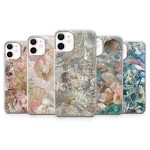 May include: Five clear phone cases with ocean-themed designs. Each case features seashells, starfish, pearls, and floral elements in pink, white, and blue. The cases are designed to fit a smartphone.