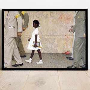 May include: Framed print of Norman Rockwell's painting, depicting a young Black girl in a white dress walking to school, escorted by U.S. Marshals. The artwork is set against a backdrop of a weathered wall and includes the artist's signature.