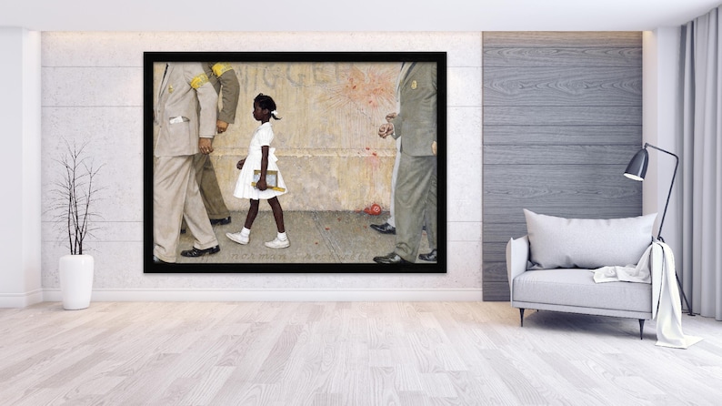 May include: A framed print of Norman Rockwell's painting, "The Problem We All Live With." It depicts a young Black girl in a white dress, escorted by U.S. Marshals, walking past a wall with a racial slur.