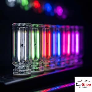 May include: A row of cylindrical glass light bulbs with internal filaments, each emitting a different color including white, green, red, blue, and purple. The bulbs are arranged in a line against a dark background with the text CarShop BY FAIZAN.