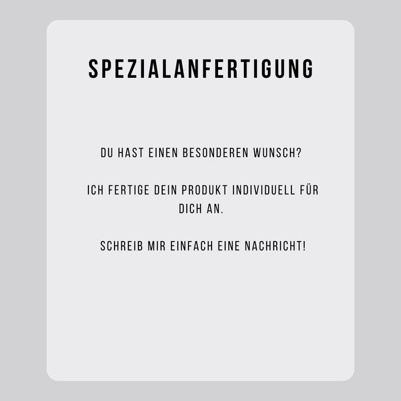May include: A white rectangular card with rounded corners, featuring black text. The text reads "SPEZIALANFERTIGUNG" at the top, followed by several lines of German text. The card is set against a light gray background.