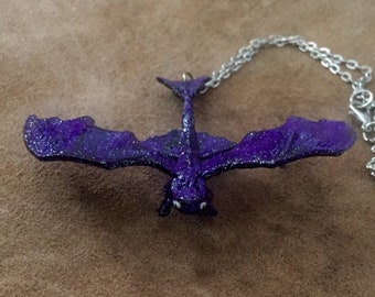 Purple glitter dragon necklace with glow in the dark eyes