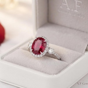Anello ovale con rubino e diamanti a pavé, gioiello di tendenza ispirato allo stile vintage.