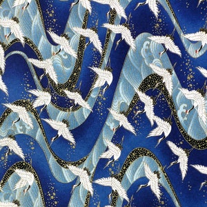 May include: A blue fabric with a repeating pattern of white cranes flying over stylized waves. The waves are a light blue and gold color. The background is a dark blue with gold flecks.