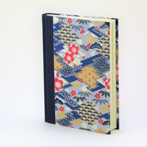 May include: A blue, gold, and red patterned hardcover journal with a dark blue spine.