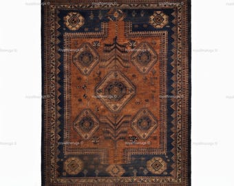 May include: A rectangular area rug featuring a central rust-orange field with a large diamond medallion and smaller diamond motifs in dark blue and cream. The rug has a wide dark blue border with geometric patterns and short fringe at both ends.