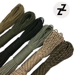 May include: Bundles of paracord in various colors, including olive green, black, and camouflage patterns. The image features a white circle with the letter "Z" repeated twice in black.
