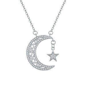 May include: Silver-toned necklace featuring a crescent moon pendant with a filigree design and a dangling star. Both the moon and star are encrusted with small, clear gemstones, creating a sparkling effect. The chain is delicate and simple.