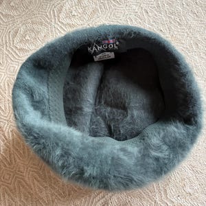 May include: A white ceramic mug with a black handle and the text "But First, Coffee" in a black, bold font. The mug is sitting on a white surface.