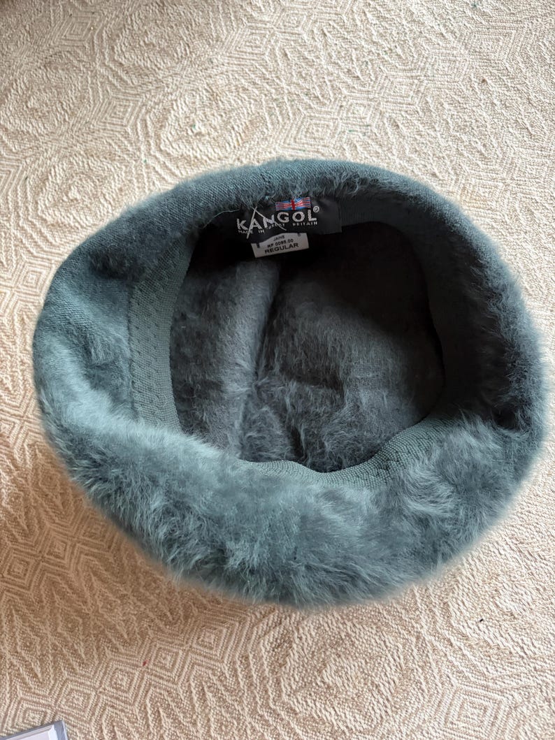 May include: A white ceramic mug with a black handle and the text "But First, Coffee" in a black, bold font. The mug is sitting on a white surface.