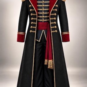 May include: A black military-style long coat featuring a deep red velvet collar and cuffs, gold-toned buttons, and gold braided epaulettes. The garment includes a matching red sash with gold fringe and a dark inner vest with gold button detailing.