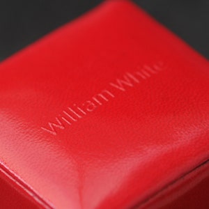 May include: A red leather box with the words "William White" embossed on the top.