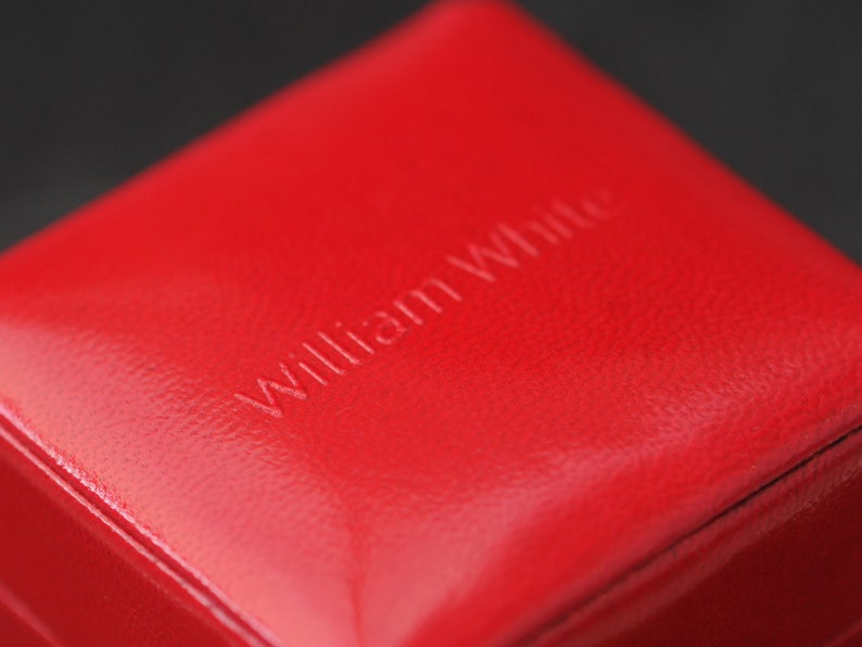 May include: A red leather box with the words "William White" embossed on the top.