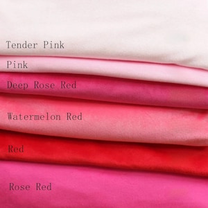 May include: Close-up of fabric swatches in various pink and red hues. The colours include Tender Pink, Pink, Deep Rose Red, Watermelon Red, Red, and Rose Red. Colour names are printed on the fabric.