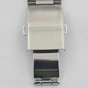 May include: A stainless steel watch clasp with the brand name "CITIZEN" engraved on the top. The clasp is rectangular with rounded edges and a hinged section below. The watch band is attached to the clasp.