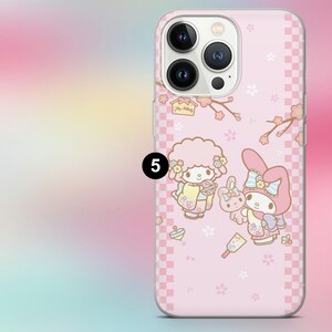 May include: Pink phone case featuring a cartoon illustration of two characters and a bunny, with cherry blossom branches and a checkered pattern. The case has a camera cutout and is designed for a smartphone.