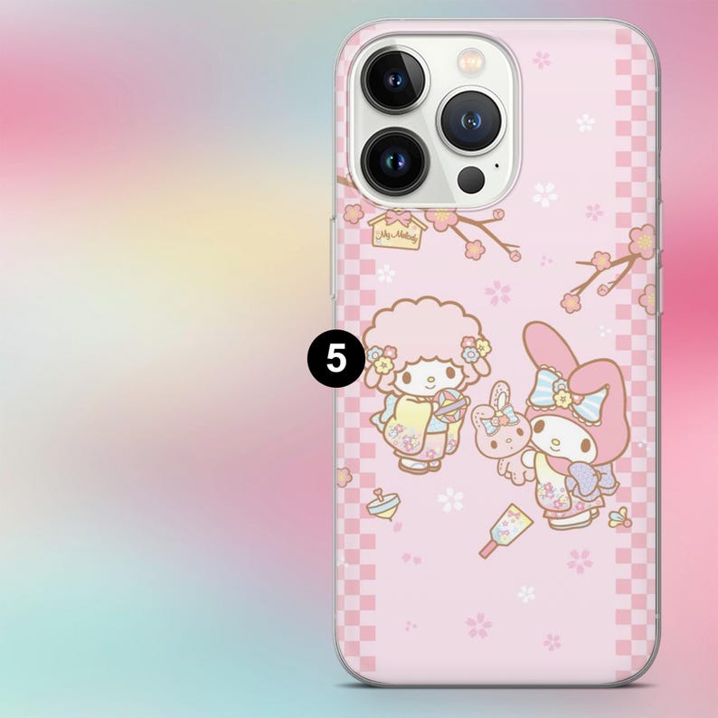 May include: Pink phone case featuring a cartoon illustration of two characters and a bunny, with cherry blossom branches and a checkered pattern. The case has a camera cutout and is designed for a smartphone.