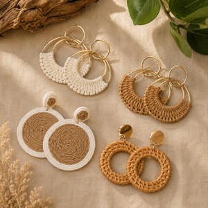 May include: Four pairs of circular earrings featuring gold-tone metal hoops and woven fiber accents. Two pairs are open hoops with white or tan woven cord, while two pairs are solid circular discs or rings wrapped in tan or white woven cord.