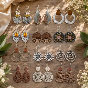 May include: A collection of twelve pairs of dangle earrings featuring various designs including sunflowers, geometric shapes, filigree patterns, and spiral motifs in silver, copper, and bronze tones with hook-style backings for pierced ears.