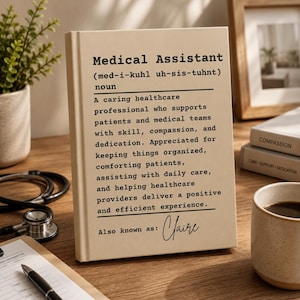 May include: A beige rectangular sign featuring black printed text that defines a Medical Assistant as a caring healthcare professional. The text includes a phonetic pronunciation, a descriptive definition, and the custom name Claire at the bottom.