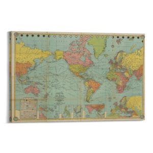 May include: A vintage-style world map print with a light blue ocean background and colorful continents. The map includes detailed geographical features and is framed with a light-colored wooden border. The map is a decorative piece for home or office.