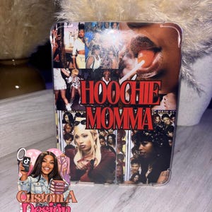 May include: Clear phone case with a collage of images and the words "HOOCHIE MOMMA" in red. The case features a design with various photos and a woman with a lollipop.