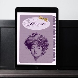 May include: A digital planner displayed on a tablet. The planner's cover is lavender with the word "Planner DIGITAL" in elegant script. A vintage illustration of a woman's face is featured below the text. A gold bow is at the top.