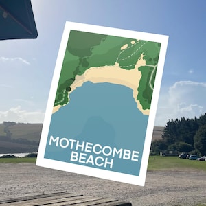May include: A poster depicting Mothecombe Beach, with a blue sea, sandy shore, and green hills. The words "MOTHECOMBE BEACH" are written in white block letters across the bottom of the image.