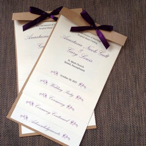 May include: A wedding ceremony program with a brown paper cover and a purple ribbon. The program lists the names of the couple, Anastasia Nicole Galt and Gary Lewis, the date of the wedding, October 28, 2017, and the order of events: Wedding Party, Ceremony, Ceremony Continued, and Acknowledgements.