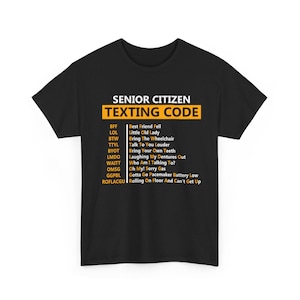 May include: Black t-shirt with the text "SENIOR CITIZEN TEXTING CODE" in white and yellow. The shirt lists texting acronyms and their meanings, such as "BFF - Best Friend Fell" and "LOL - Little Old Lady."