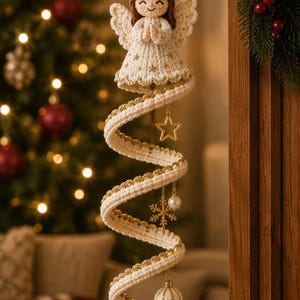 May include: A crocheted angel ornament with brown hair, a gold halo, and a cream-colored dress featuring gold star accents. A long, spiraling cream crochet ribbon hangs below, decorated with a gold star, a snowflake, a pearl, and a small ball.