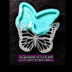 May include: A clear silicone mold shaped like a butterfly. The mold is designed to create resin or food-safe projects. The text "Available in CLEAR (UV resin & food safe)" is visible below the mold.
