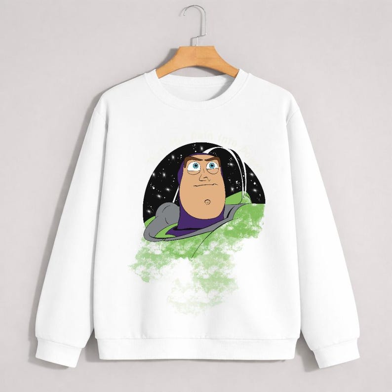 May include: White crew neck sweatshirt featuring a cartoon illustration of Buzz Lightyear from Toy Story. The graphic shows Buzz in his space suit against a starry background. The sweatshirt is a casual, comfortable style.