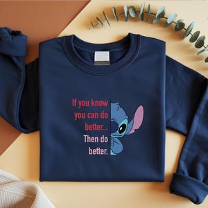 May include: Navy blue sweatshirt featuring a graphic of Stitch from Lilo & Stitch, with the text "If you know you can do better... Then do better." The design includes Stitch's face and the quote in pink and white.