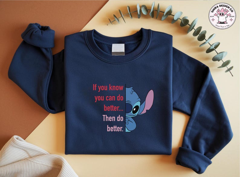 May include: Navy blue sweatshirt featuring a graphic of Stitch from Lilo & Stitch, with the text "If you know you can do better... Then do better." The design includes Stitch's face and the quote in pink and white.