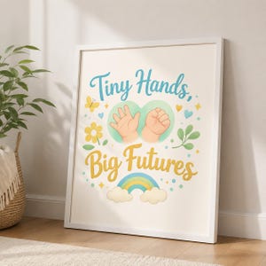 May include: A framed wall art print featuring the text "Tiny Hands, Big Futures" in blue and yellow script. The design includes illustrations of two baby hands, a yellow flower, a butterfly, green leaves, and a colourful rainbow with clouds.