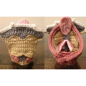 May include: A crocheted anatomical model of the female reproductive system. The model is made with pink, beige, gray, and white yarn. The model is shown from two different angles.