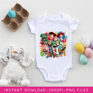 May include: White baby onesie featuring a colorful graphic of Toy Story characters. The design includes Woody, Buzz Lightyear, Rex, Jessie, and other characters. The onesie is surrounded by Easter eggs and a stuffed bunny.