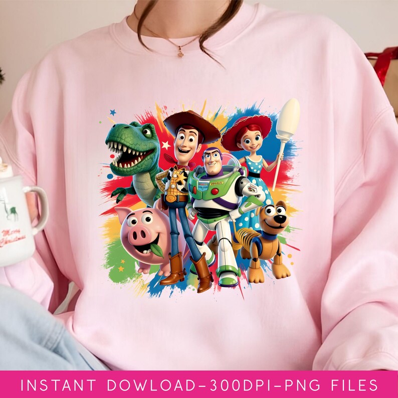 May include: A light pink sweatshirt featuring a colorful graphic of characters from the Toy Story movie. The graphic includes Woody, Buzz Lightyear, Rex, Hamm, Jessie, and Slinky Dog. The text "INSTANT DOWNLOAD - 300DPI - PNG FILES" is at the bottom.