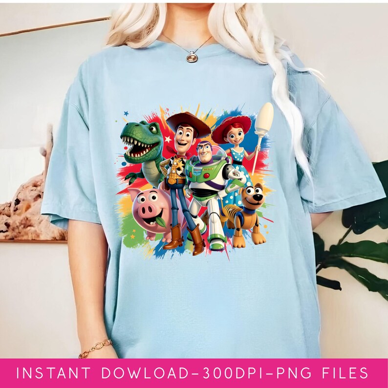 May include: Light blue t-shirt featuring a colorful graphic of characters from the animated movie Toy Story. The design includes Woody, Buzz Lightyear, Rex, Hamm, Jessie, and Slinky Dog. The text "INSTANT DOWNLOAD - 300DPI - PNG FILES" is at the bottom.