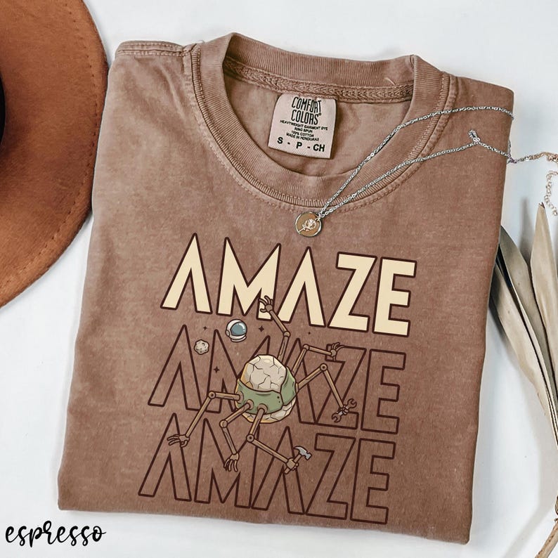 This retro sci-fi alien shirt blends humor, fandom, and bookish style in one comfortable tee. Designed for readers who appreciate intelligent space stories and memorable characters, it’s a subtle nod to one of the most beloved modern sci-fi novels. A fantastic addition to any book lover’s wardrobe.