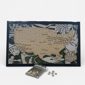 May include: Wooden baseball-themed map of the United States with cut-out states and baseball-related graphics. Includes a bag of small, round tokens and a few tokens scattered nearby. The map is framed in black.
