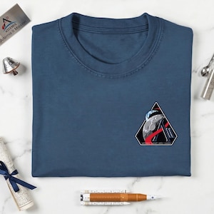 May include: A white ceramic mug with a black handle and the text "But First, Coffee" in a bold, black font. The mug is set against a neutral background, highlighting its simple design.