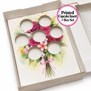 May include: A white cardboard cupcake box containing a printed insert with six circular cutouts. The insert features a watercolor illustration of a floral bouquet with pink and red roses, green leaves, and a pink ribbon. Text reads: Printed Cupcake Insert + Box Set.