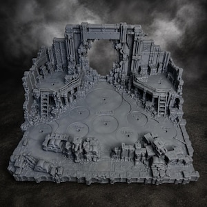 May include: A grey resin miniature display base featuring a ruined industrial structure with a central archway, elevated platforms with ladders, and multiple circular indentations labelled 32mm, 40mm, and 50mm for positioning gaming figures.